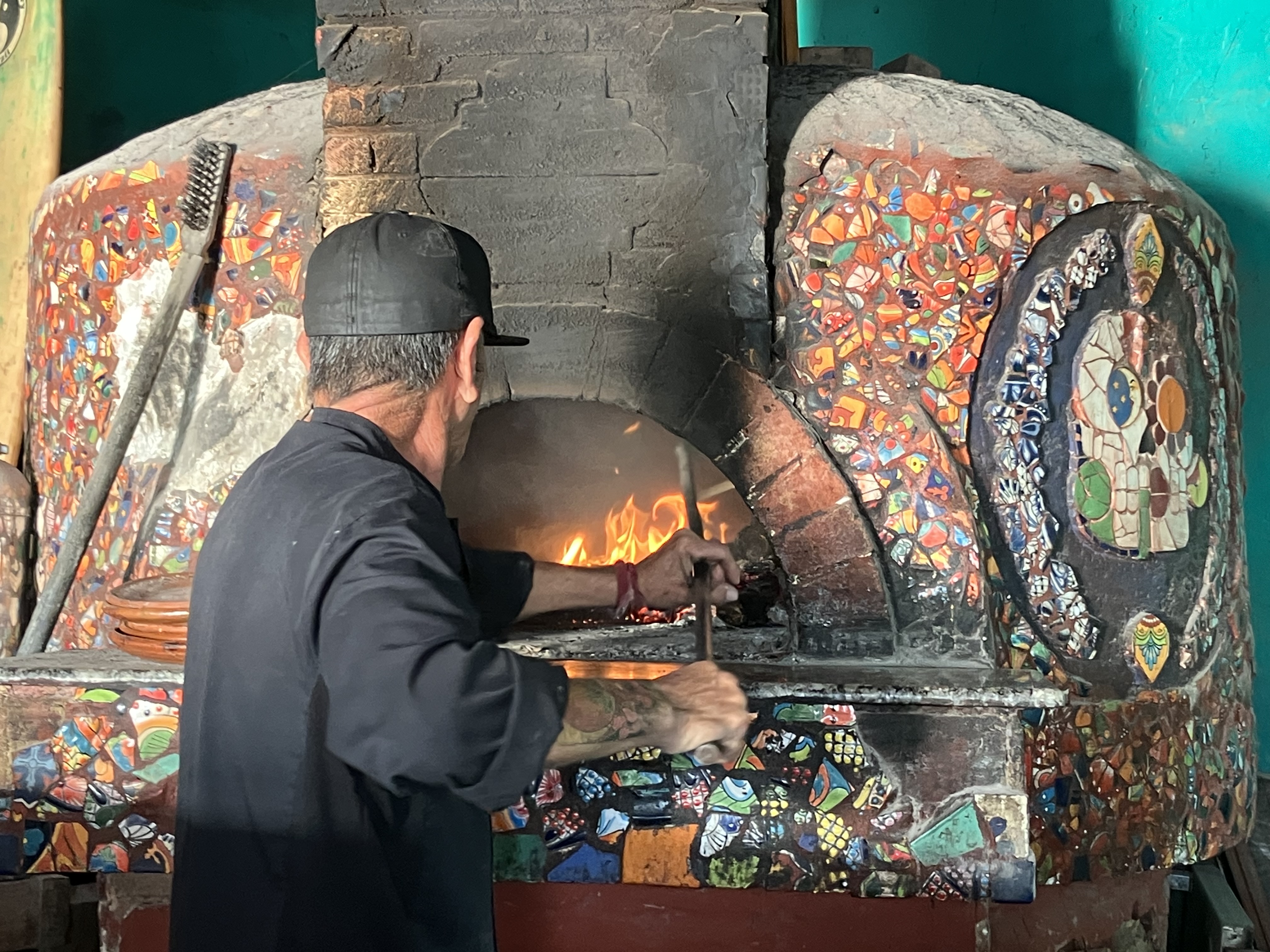 working the pizza oven at La Catrina