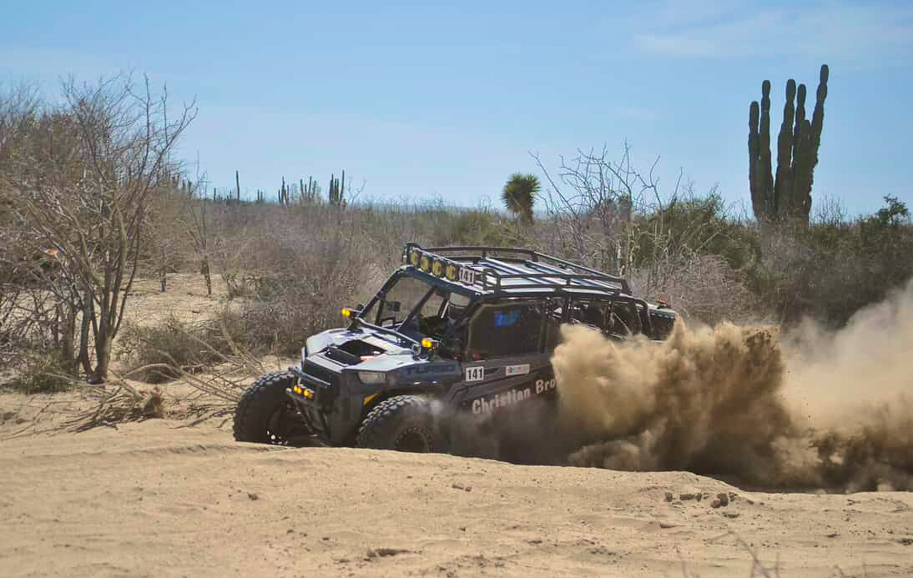 A race razr drives across the Baja desert dust