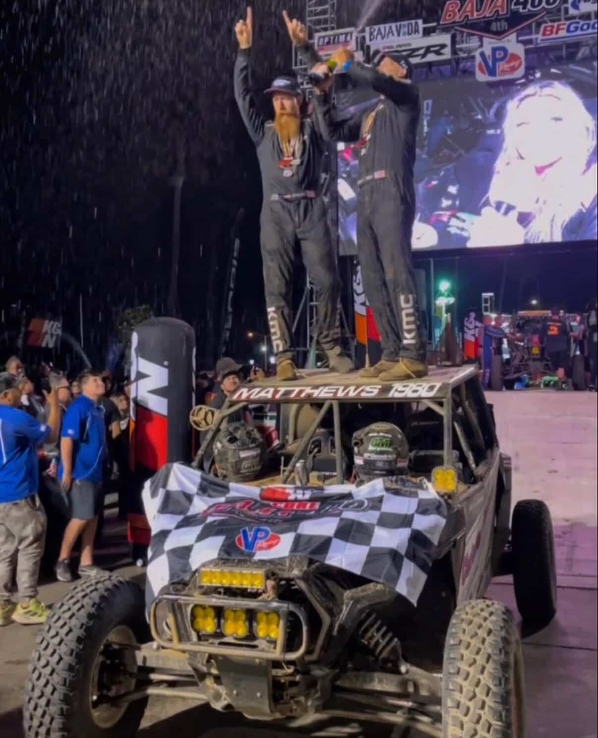 Gabe and Luke Matthews celebrate standing on top of their razr race ATV
